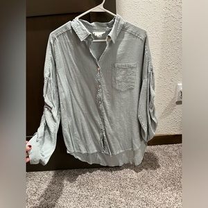 Button up shirt. Sage green/blueish color. Ruching on arms- can be adjusted.